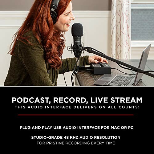 Woman using audio interface for podcasting and recording at a desk.