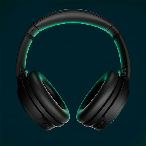 Black headphones with green glow on dark background