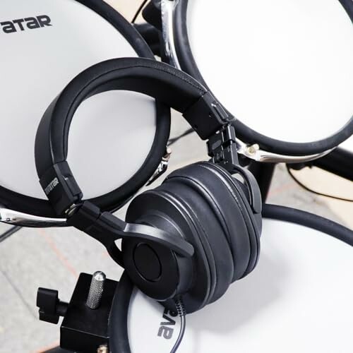 Headphones resting on electronic drum kit.