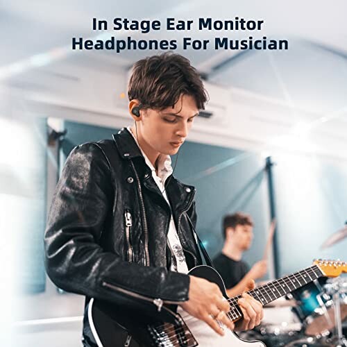 Musician wearing ear monitor headphones playing guitar.